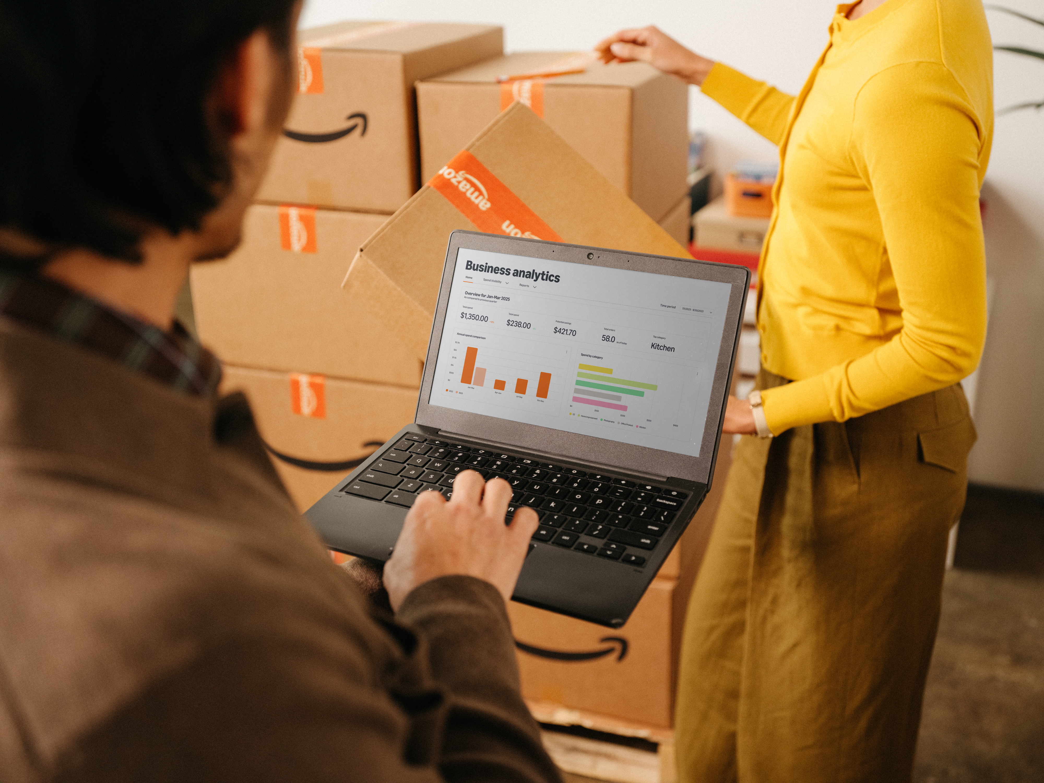 Two coworkers having an animated discussion in a modern office space.